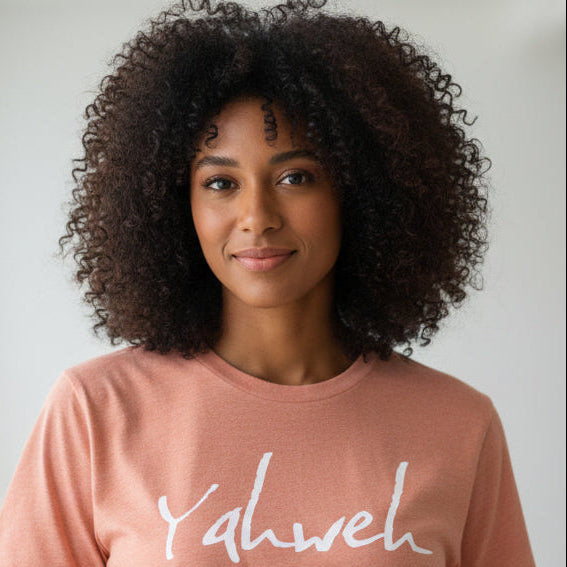 Person wearing a heather pink t-shirt with 'Yahweh' 