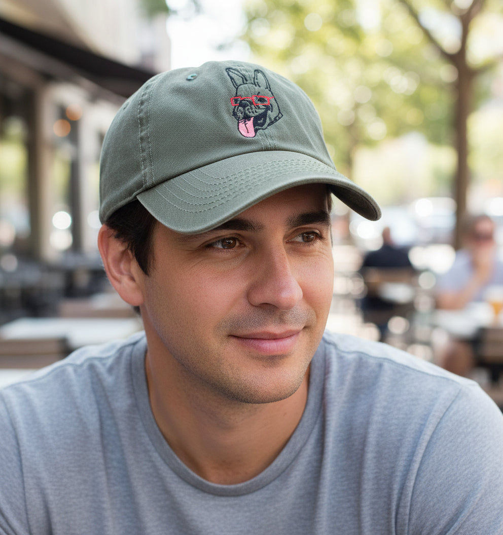 Green cap with an embroidered french bulldog wearing glasses.