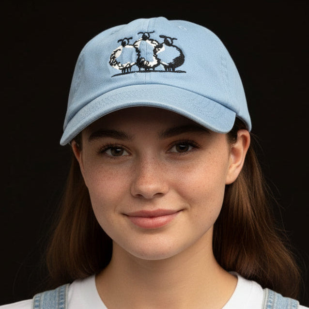light blue cap with embroidered sheep on girl